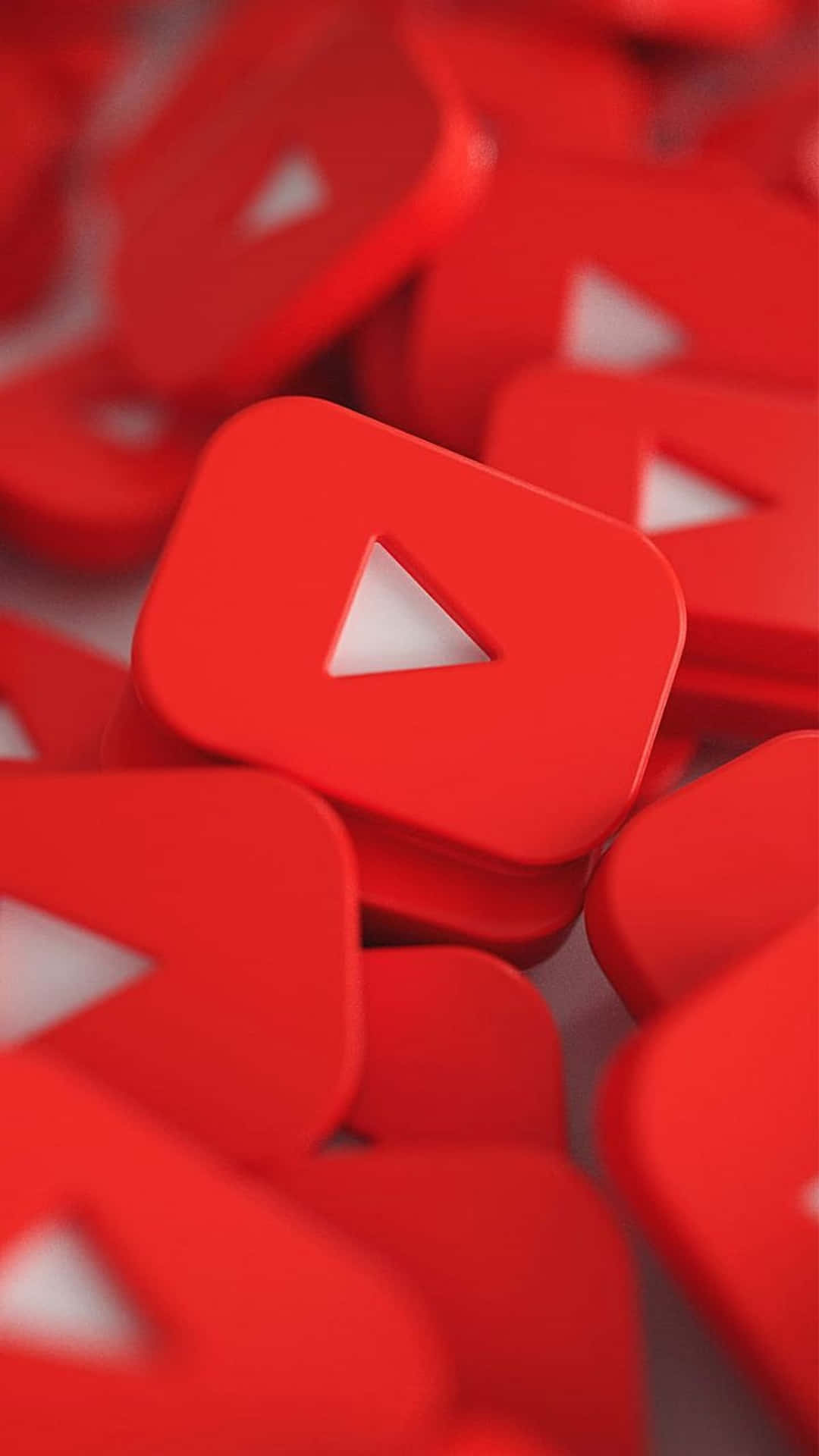淺景深中散落的亮面紅色 YouTube 播放按鈕。