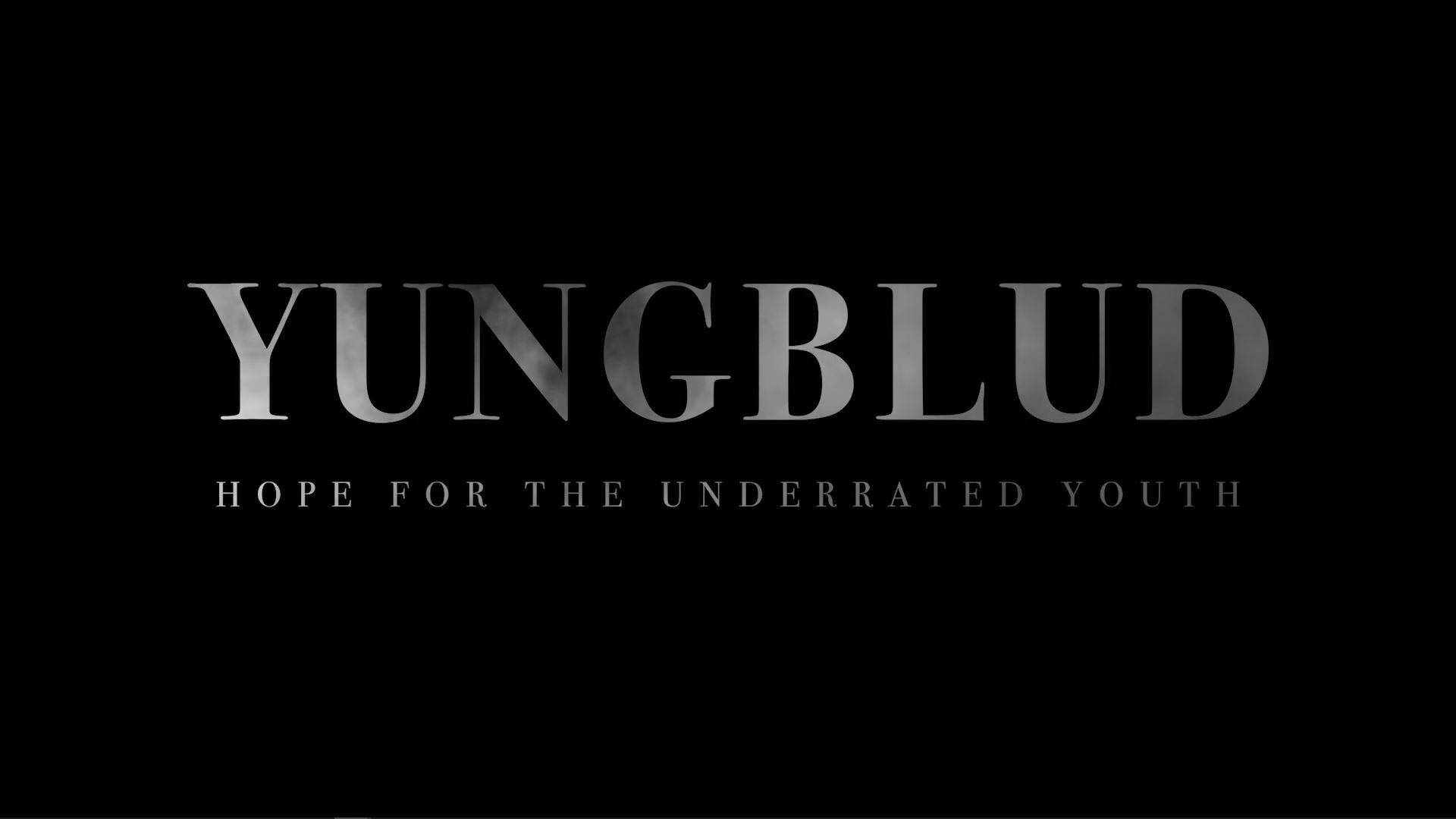 YUNGBLUD 標誌及標語 Hope for the Underrated Youth 以銀色顯示在黑色背景上。