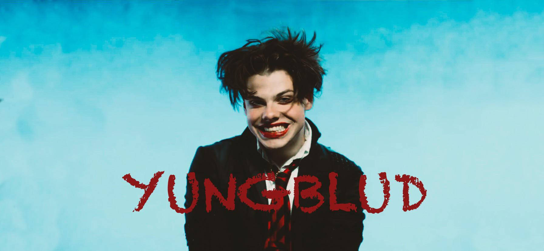 Yungblud《Psychotic Kids!》音樂錄影帶粉絲製作海報 壁紙 — 一個頭髮凌亂、塗著鮮紅色唇膏的人，在藍天下咧嘴而笑，下方有紅色的YUNGBLUD字樣。