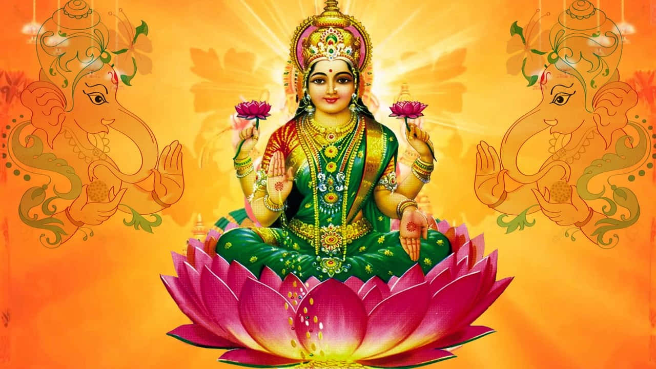  壁紙 — 一位光彩照人的女神，身披綠色與金色，優雅地坐在粉紅蓮花上，兩側有兩頭大象，背景是發光的橙色。