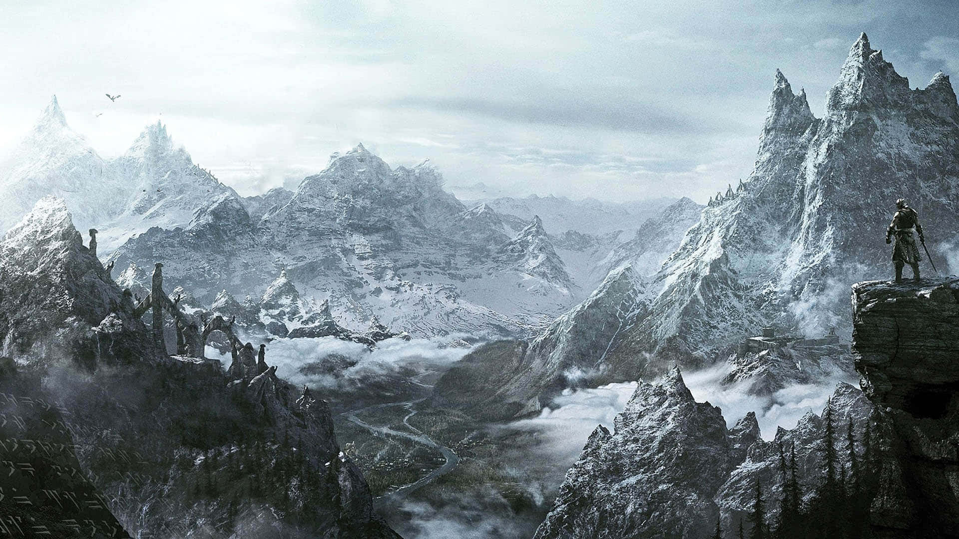 Skyrim Landscapes 桌布 壁紙 — 一位孤獨的戰士站在白雪覆蓋的山頂上，俯瞰著被迷霧籠罩的廣闊山谷，鋸齒狀的山峰刺破陰沉的天空。