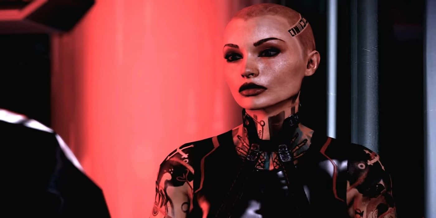 Mass Effect Jack 桌布 壁紙 — 一位帶有發光紅色點綴和複雜紋身的賽博格女性在昏暗的未來感房間中凝視著。
