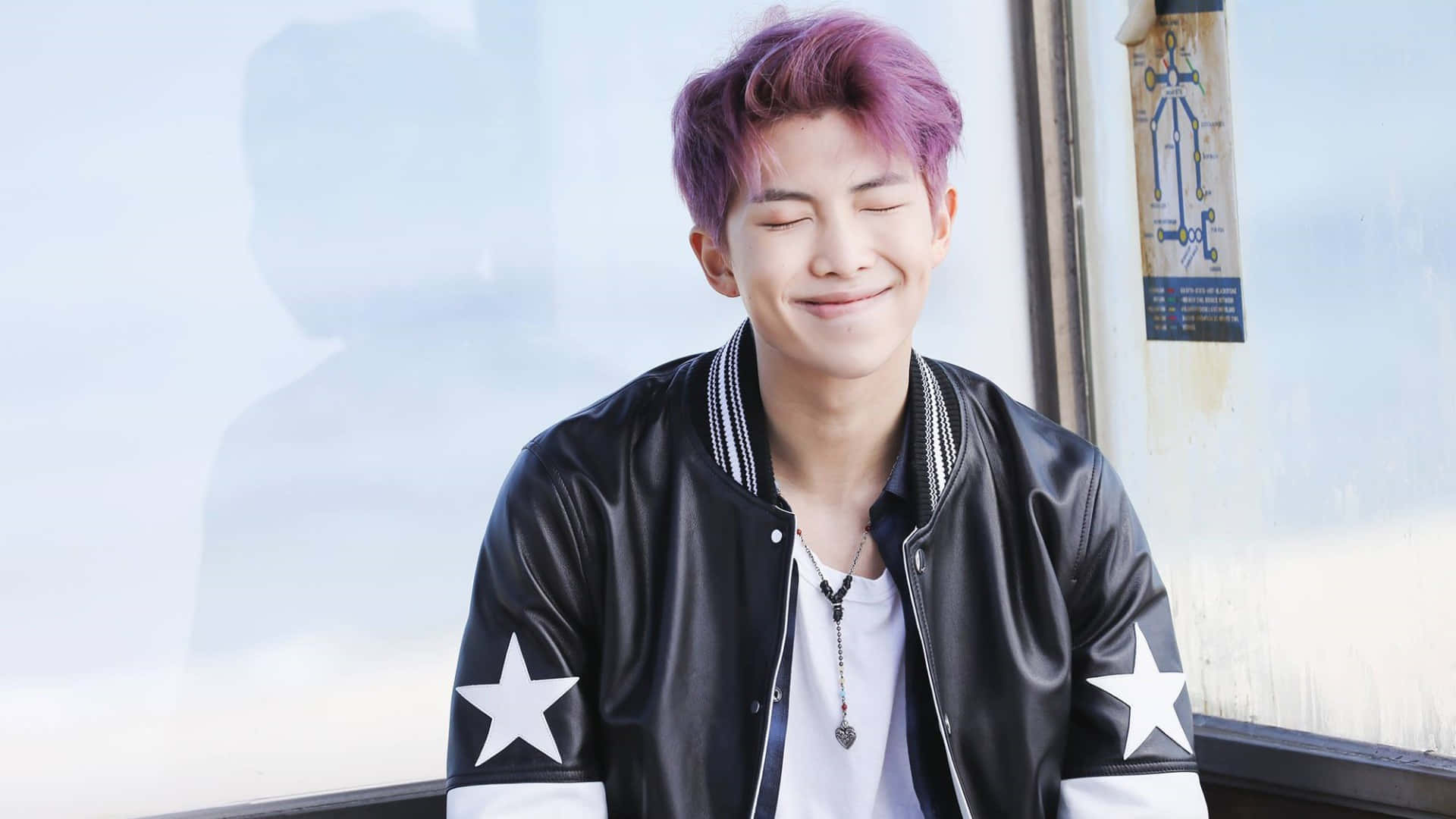 Bts Rap Monster 桌布 壁紙 — 一位擁有鮮豔紫色頭髮的年輕男子，穿著帶有白色星星的黑色皮夾克，滿足地微笑。