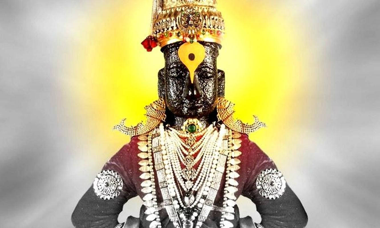 hanuman art 桌布 壁紙 — 一位深色皮膚的神祇，裝飾著華麗的金飾和燦爛的黃色光環，莊嚴地站在柔和的灰色背景前。