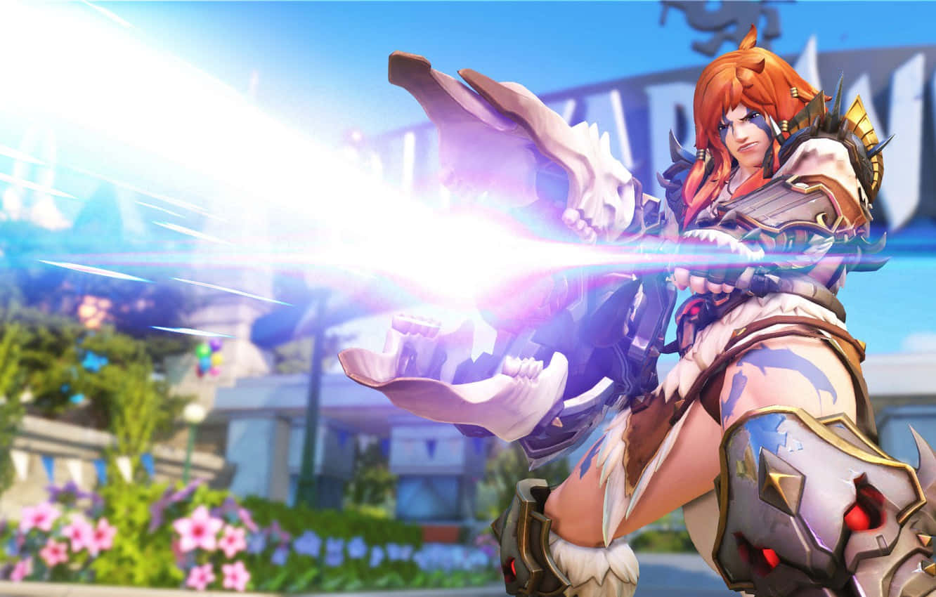 Overwatch Zarya 桌布 壁紙 — 一位火紅頭髮的戰士穿著華麗盔甲，在充滿活力的戶外環境中釋放出發光的能量爆炸。