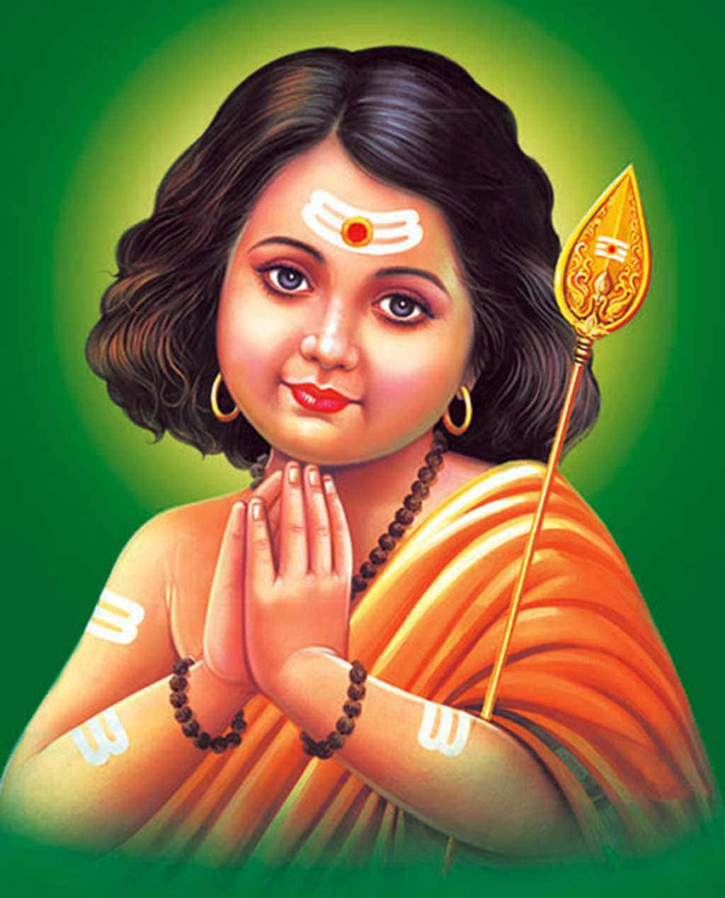 Murugan 桌布 壁紙 — 一位神聖的兒童女神，黑髮，穿著橙色紗麗，手持金色長矛，在發光的綠色光環中祈禱。