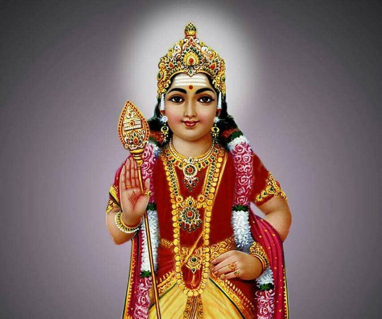 Hindu God 桌布 壁紙 — 一位神聖的印度教女神，身著紅金服飾，佩戴精緻珠寶，頭頂光環，手持聖器。