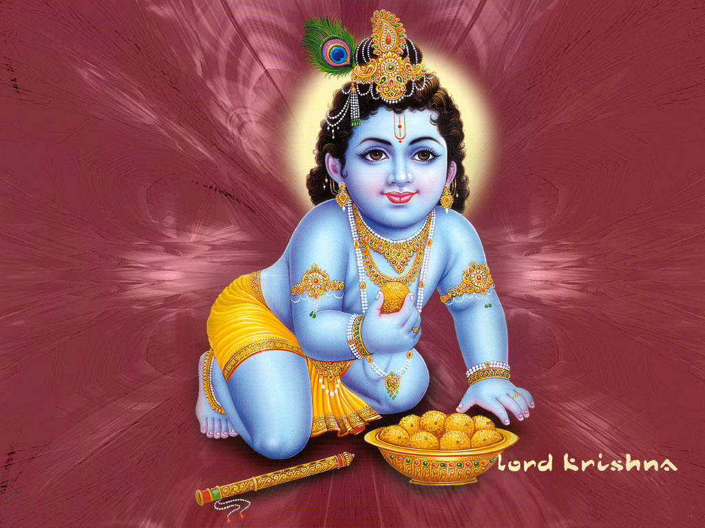 Bal Krishna 桌布 壁紙 — 一位神聖的藍皮膚兒童神祇，佩戴金色珠寶和黃色多蒂，優雅地坐著，在明亮的栗色背景前手持糖果。