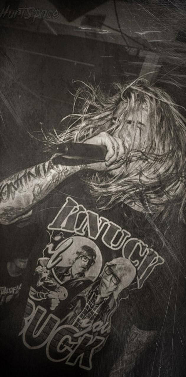 Ghostemane 桌布 壁紙 — 一位紋身音樂人頭髮凌亂，穿著圖案T恤，在黑白粗獷的演唱會鏡頭中對著咪高峰嘶吼。