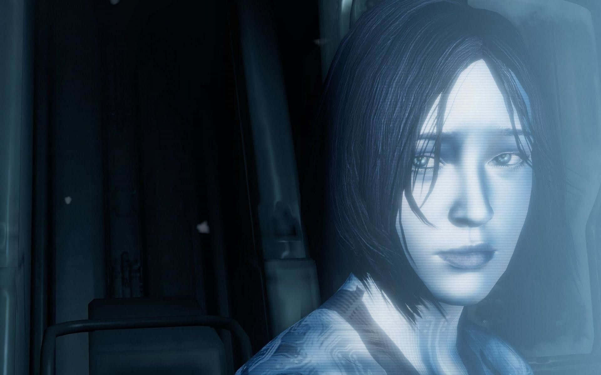 Halo Cortana 桌布 壁紙 — 一位蒼白的短黑髮女性在昏暗的藍色調室內向前凝視，身後有模糊的機器。