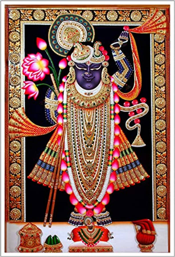 Shrinathji 桌布 壁紙 — 一位裝飾華麗的紫色皮膚印度教神祇，飾有精緻的金飾和粉紅蓮花，鑲嵌在華麗的金色邊框中。