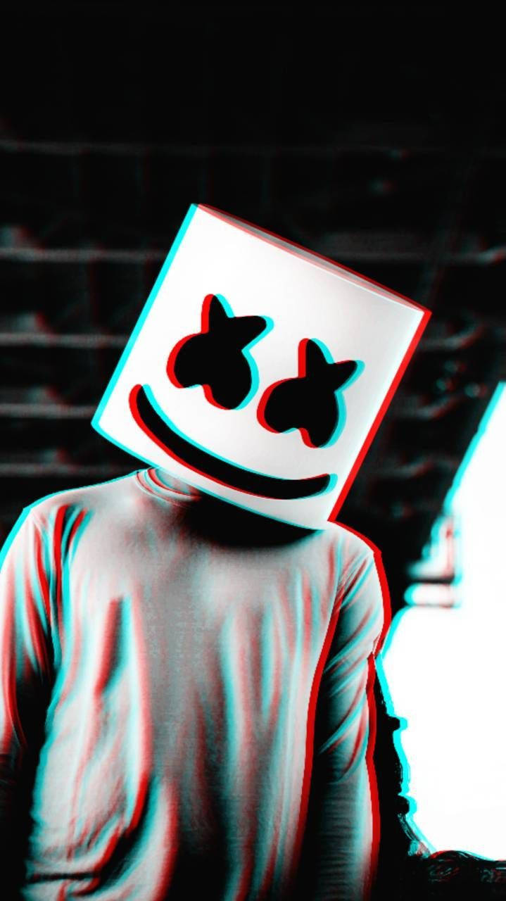 Marshmello 桌布 壁紙 — 一個人戴著白色方形面具，面具上有笑臉和星星眼睛，以紅色和青色色差效果呈現，背景是深色磚牆。