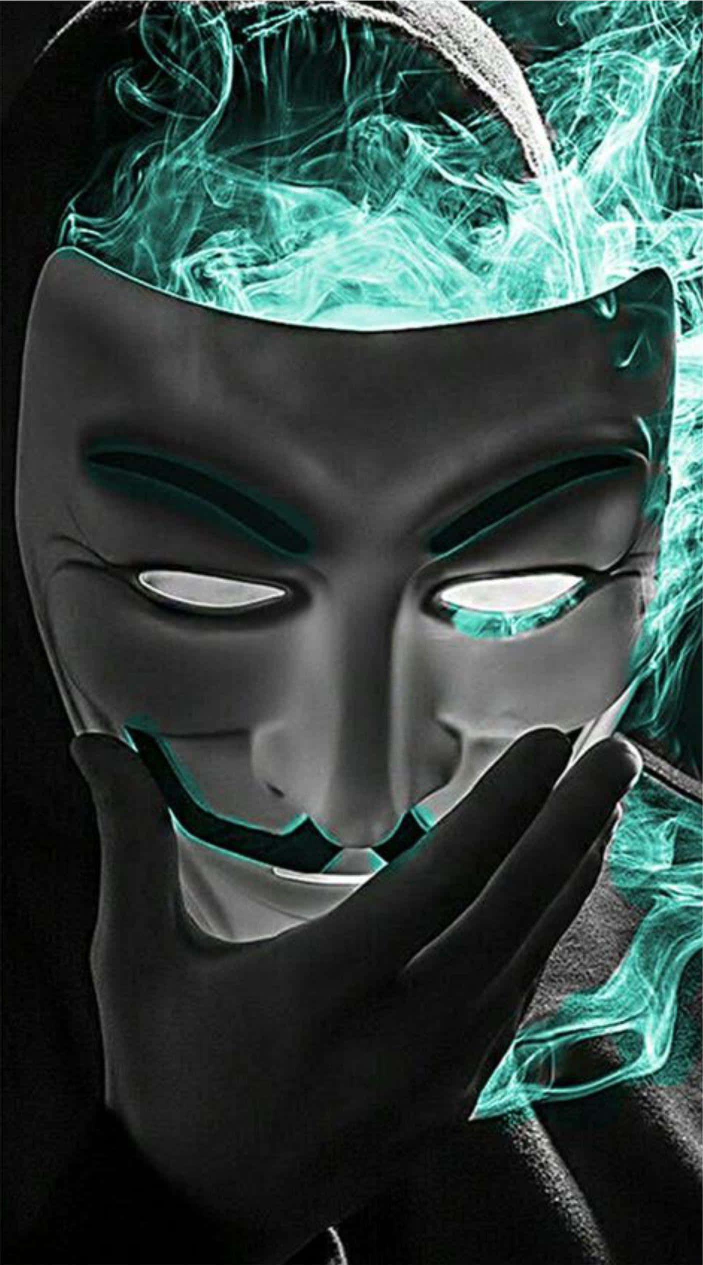 Anonymous 桌布 壁紙 — 一個人戴著蓋伊·福克斯面具，頭部冒出發光的青綠色煙霧，在黑暗背景中盤旋。