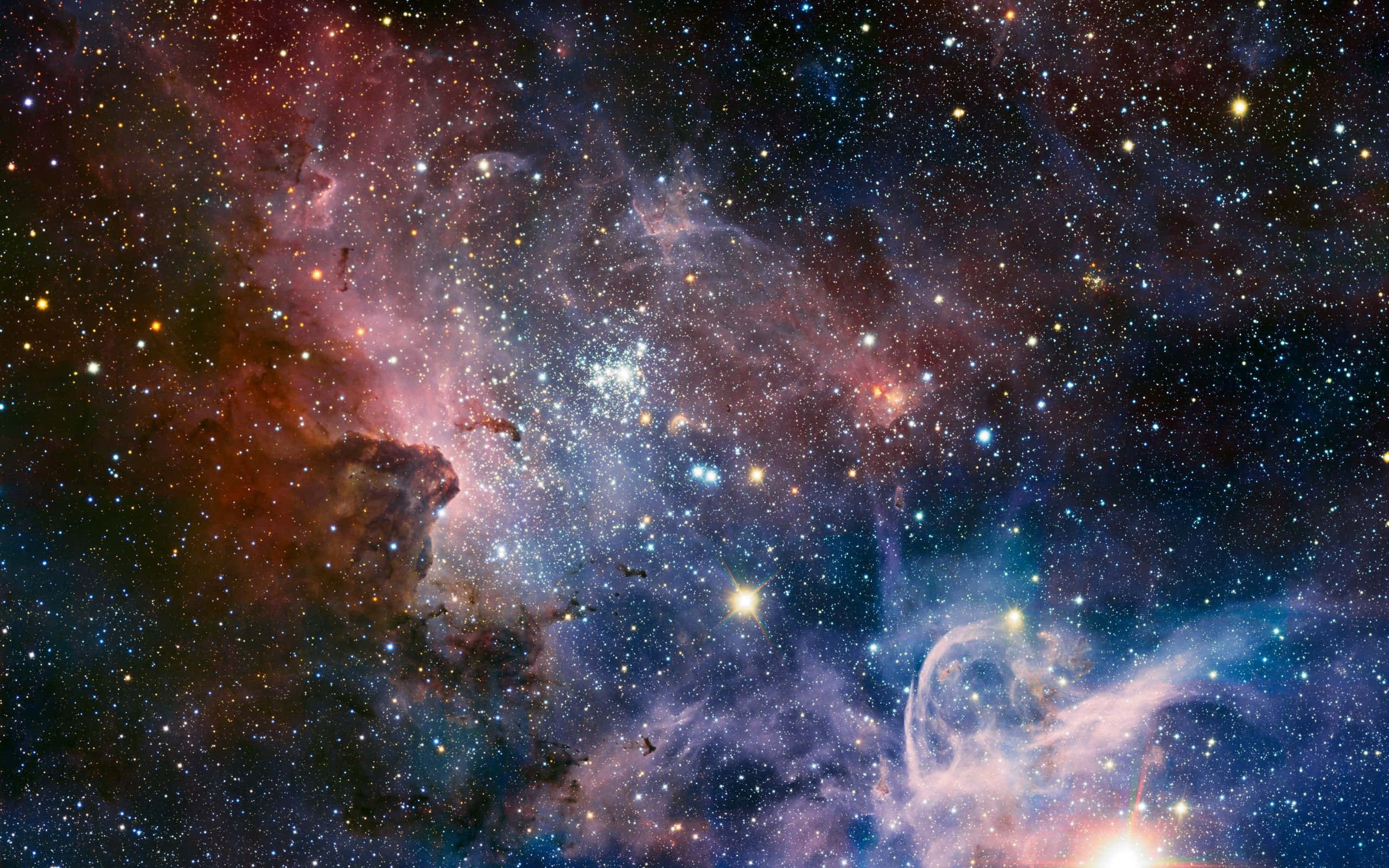 Colorful Space 桌布 壁紙 — 一個令人嘆為觀止的宇宙場景，充滿了在繁星點點的黑暗虛空中旋轉的發光星雲，呈現出鮮豔的粉紅色、藍色和橙色。