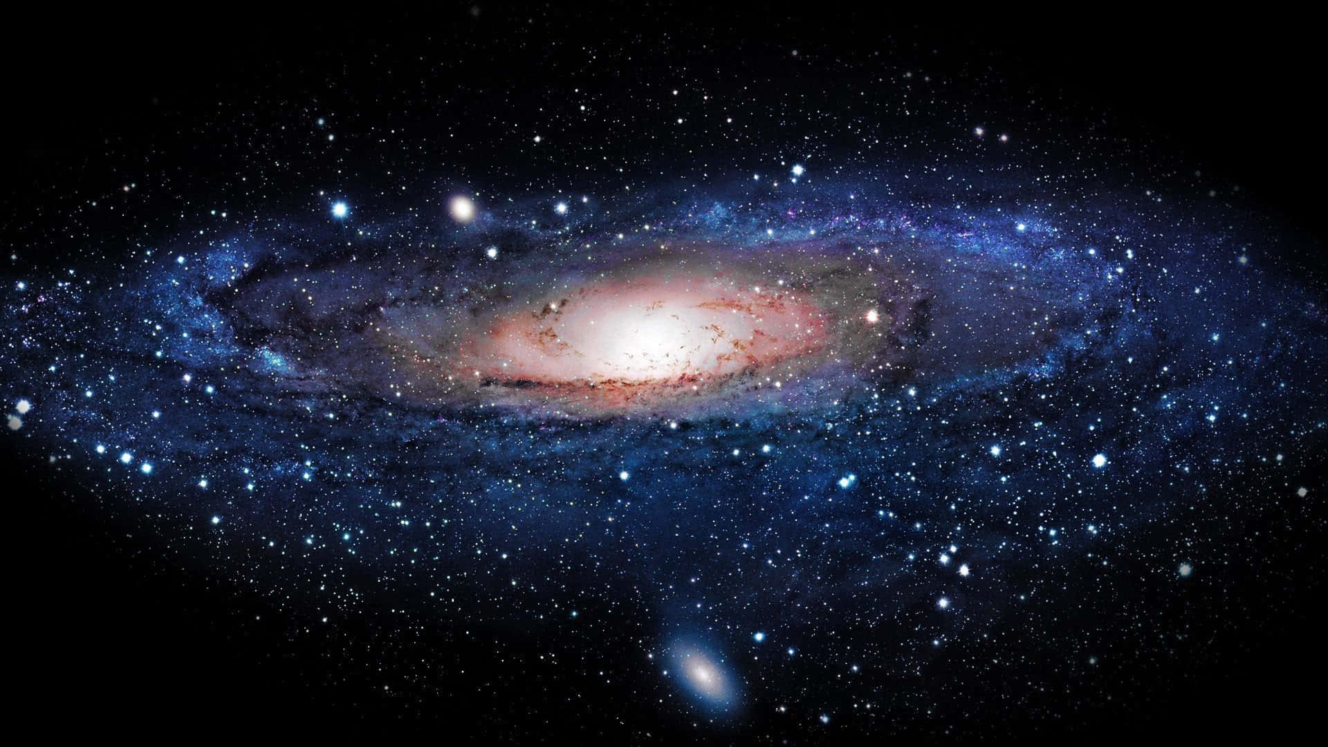 Universe 桌布 壁紙 — 一個令人嘆為觀止的螺旋星系，在佈滿星辰的黑色虛空中閃耀著藍色和粉紅色的色調。