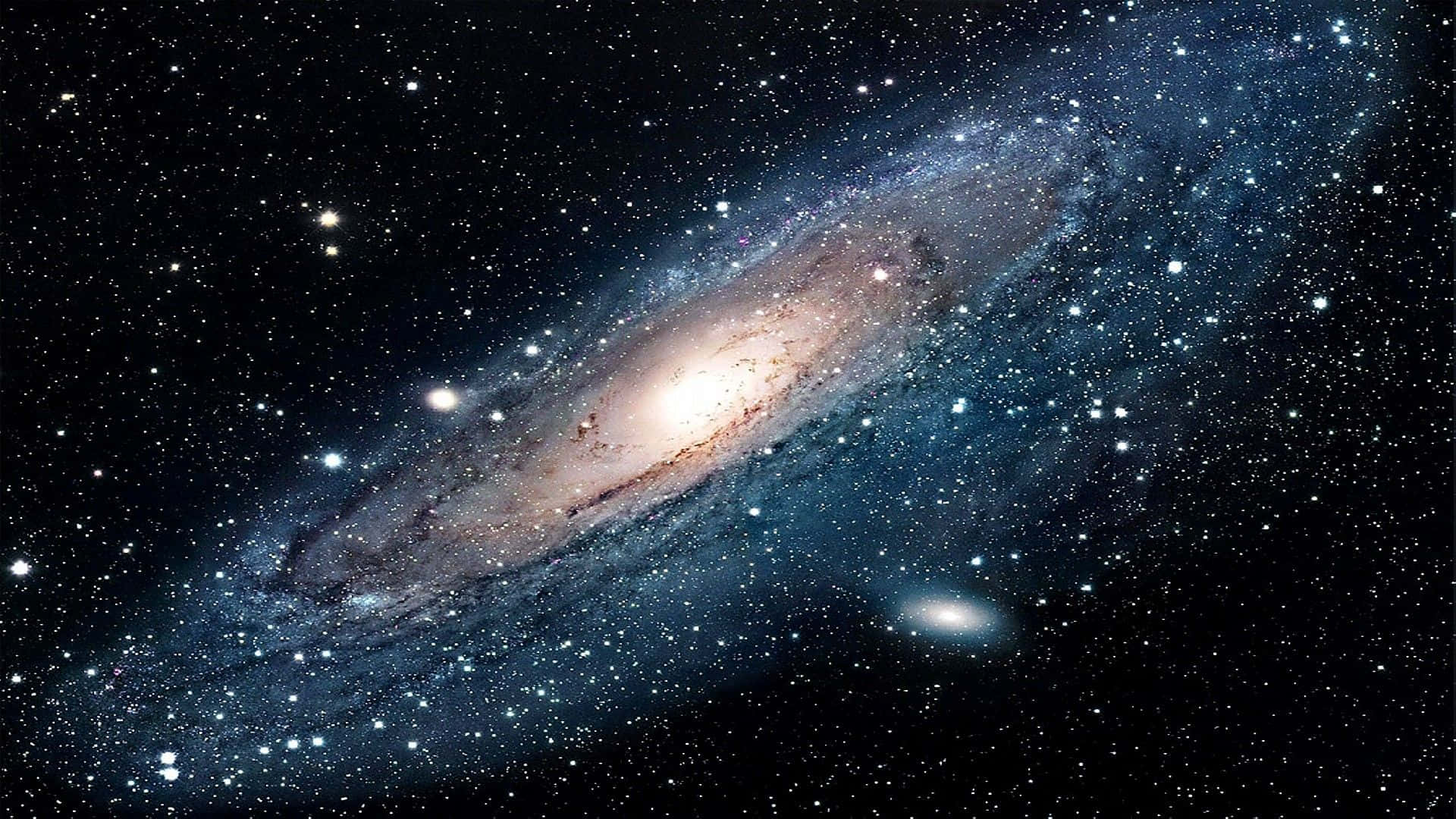 Cool Space 桌布 壁紙 — 一個令人嘆為觀止的螺旋星系，在星空中閃耀著金色核心和藍色旋臂。
