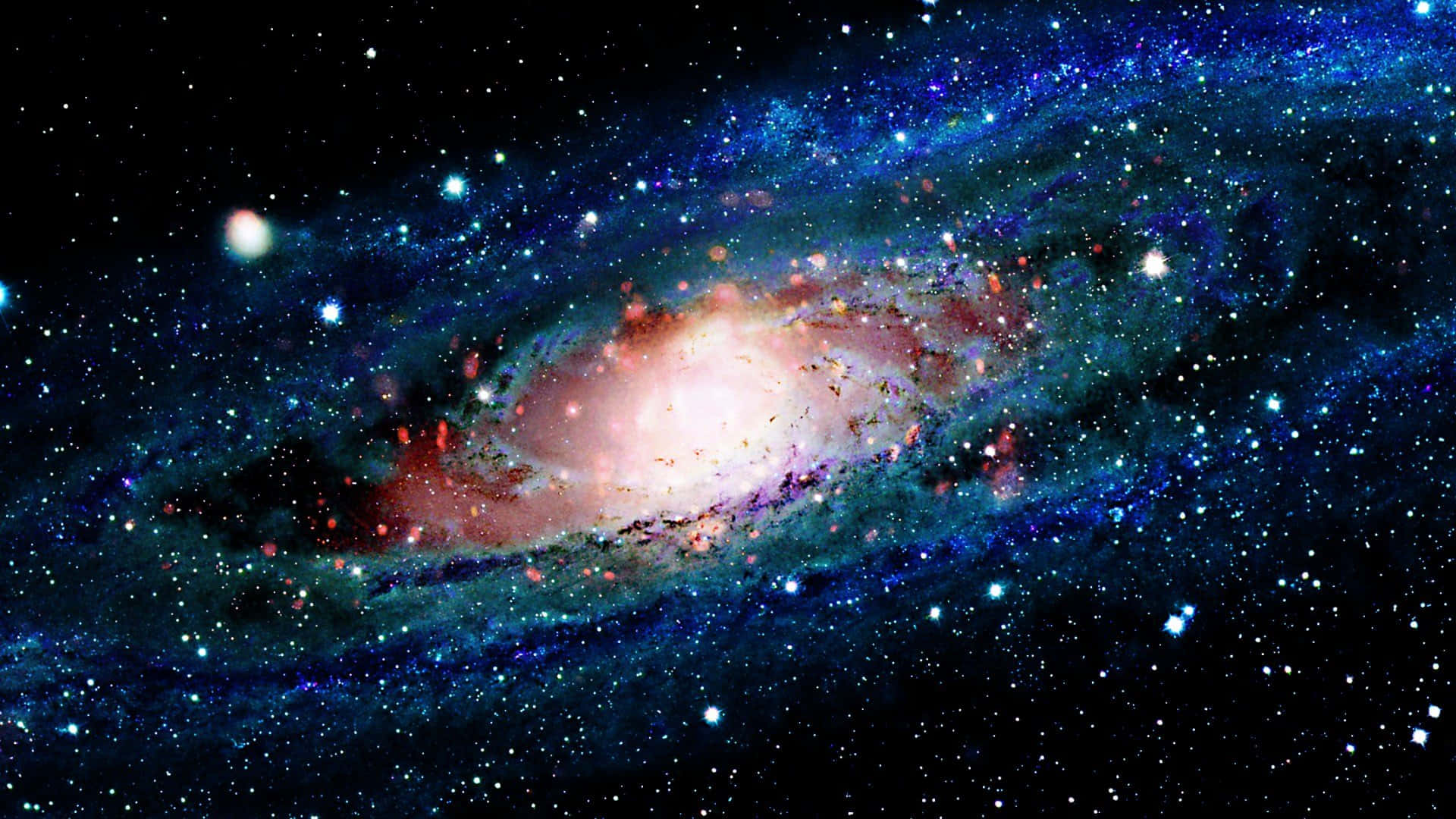 Cool Space 桌布 壁紙 — 一個令人嘆為觀止的螺旋星系，在繁星點點的宇宙背景下散發出粉紅色和藍色的光芒。
