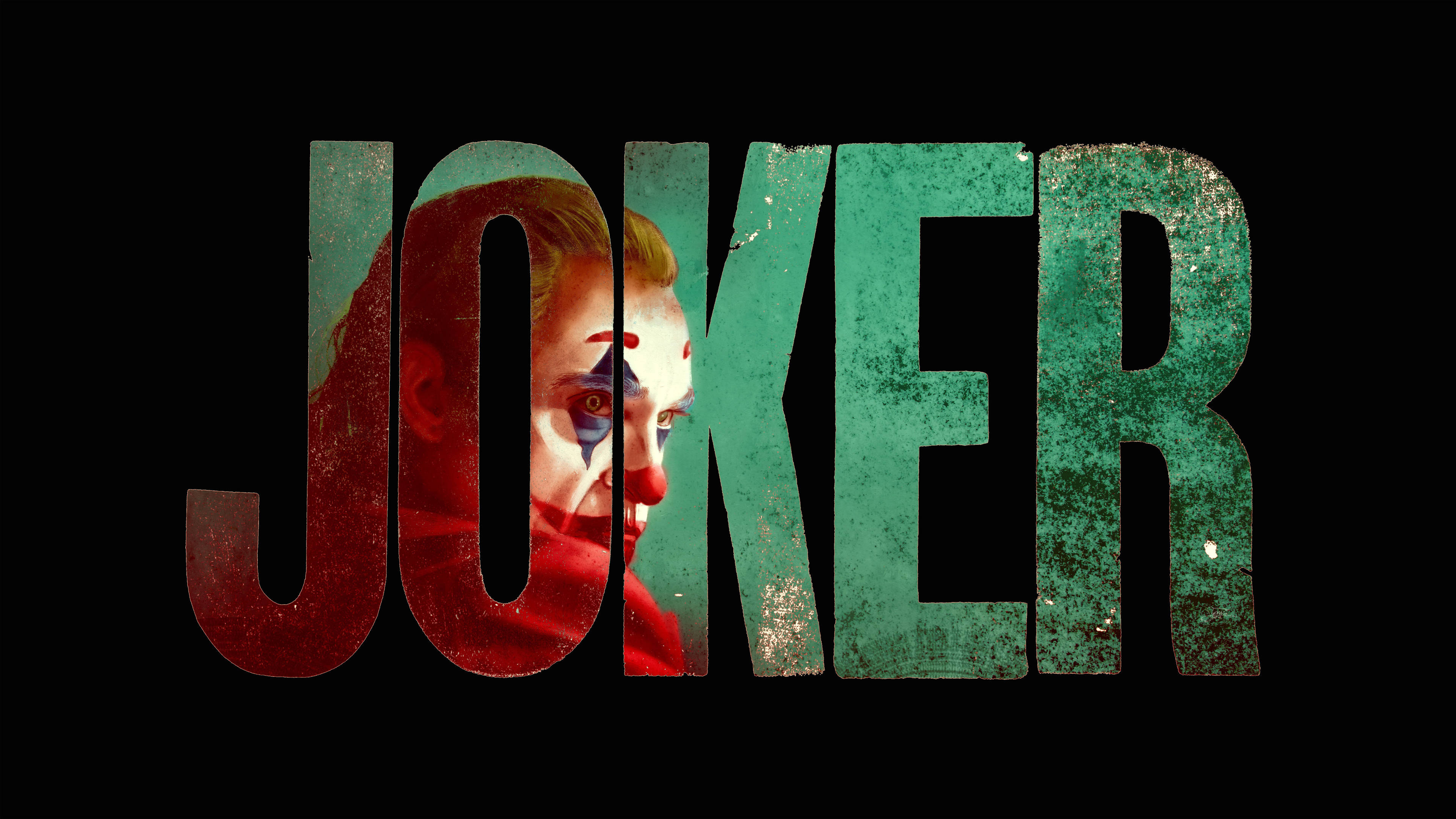 小丑 桌布 壁紙 — 一個令人畏懼的小丑臉孔從JOKER這個字的破舊字母間窺視出來，背景為黑色。