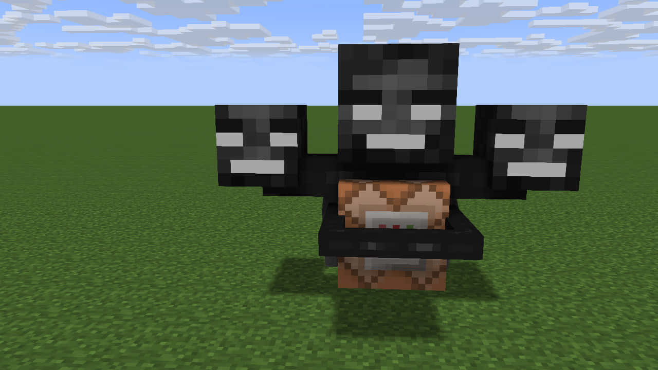 Minecraft Wither Boss 桌布 壁紙 — 一個像素化的 Minecraft 喪屍有三個頭，站在綠色草地上，藍天白雲。