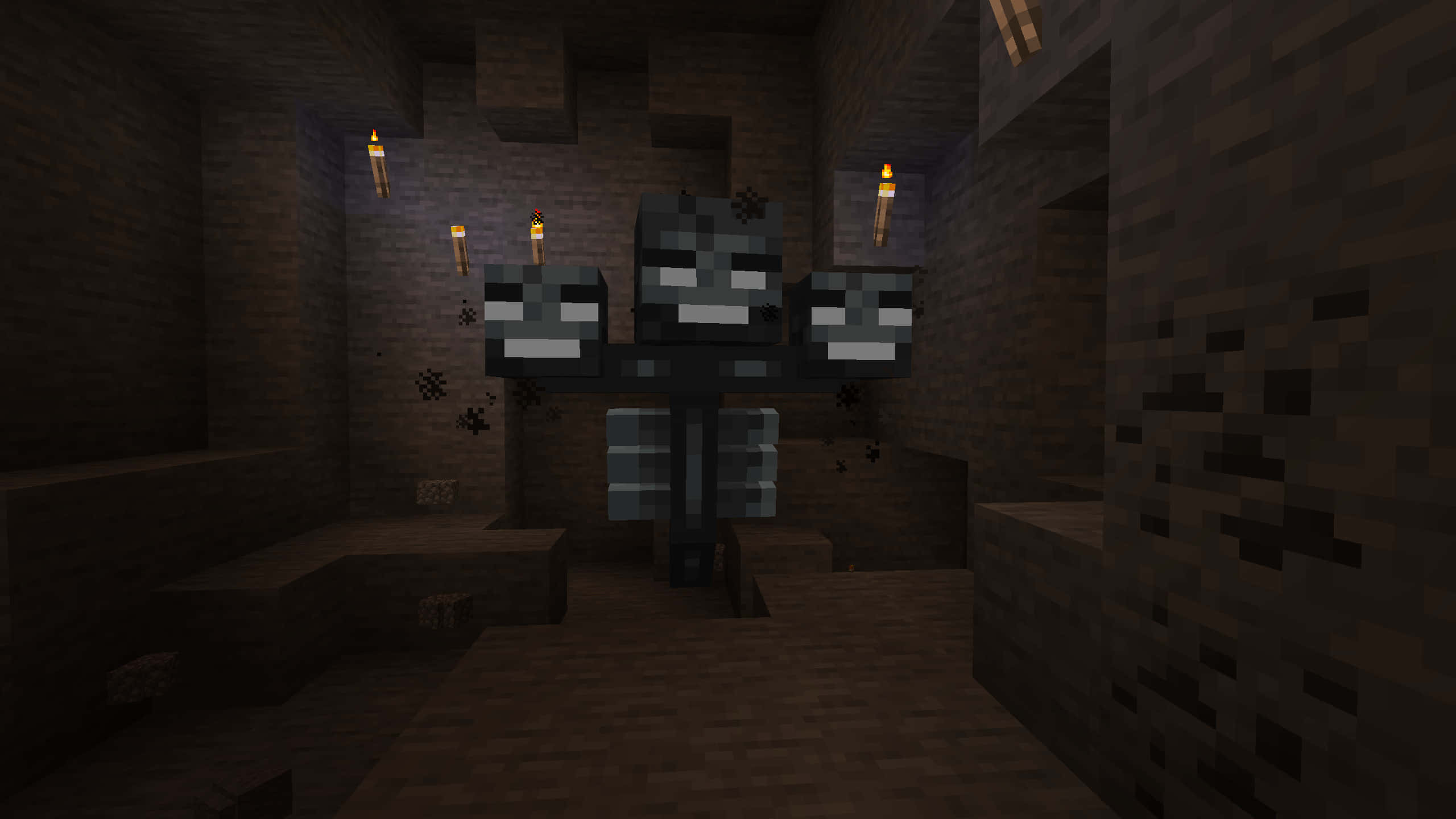 Minecraft Wither Boss 桌布 壁紙 — 一個像素化的 Minecraft 喪屍站在昏暗的石頭地牢中，火炬在磚牆上投射出搖曳的光芒。