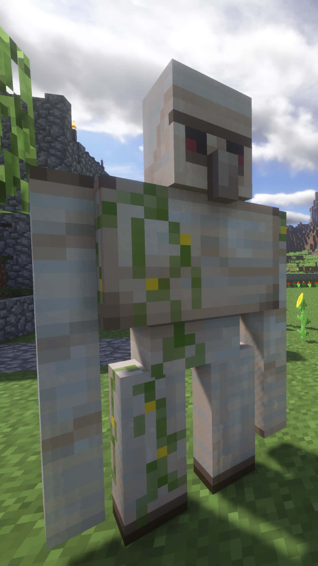 Minecraft Iron Golem 桌布 壁紙 — 一個像素化的 Minecraft 殭屍站在草地上，天空多雲，附近有石頭廢墟。