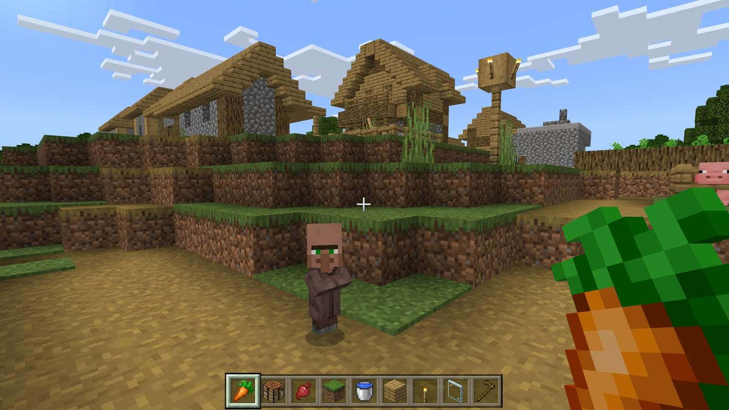 Minecraft Villager 桌布 壁紙 — 一個像素化的Minecraft村民站在一個有木屋的草地村莊，藍天白雲下。