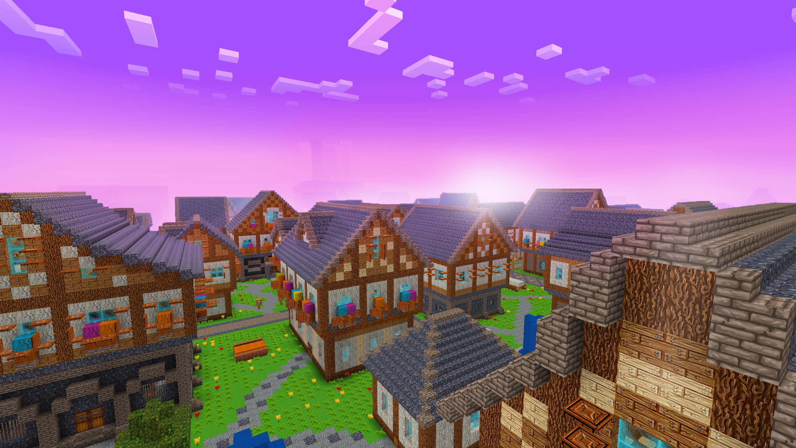 Minecraft Adventure 桌布 壁紙 — 一個像素化的Minecraft村莊，有木屋和鵝卵石小路，在充滿活力的紫色日落天空下。