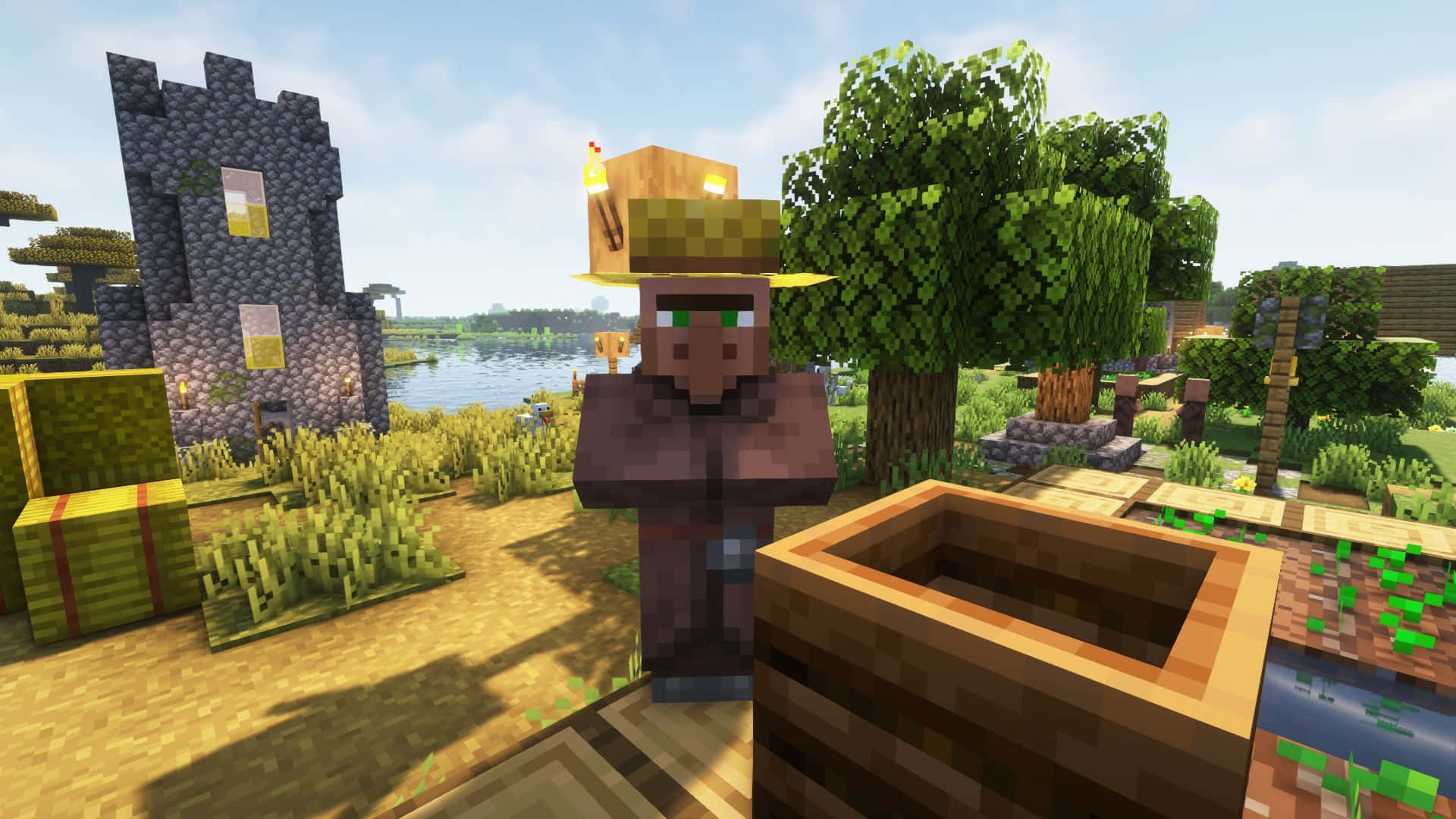 Minecraft Villagers 桌布 壁紙 — 一個像素化的Minecraft村民站在木井旁邊，旁邊有石塔和茂密的綠樹，天空明亮。