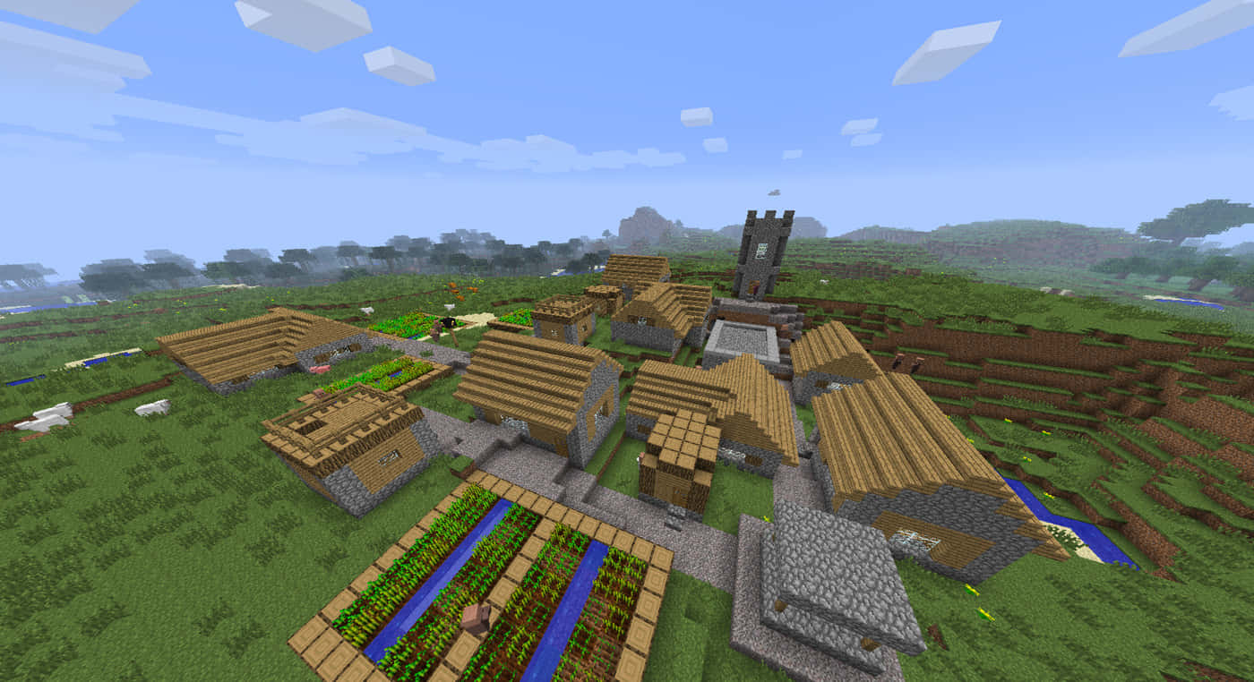 Minecraft Villages 桌布 壁紙 — 一個像素化的Minecraft村莊，坐落於長滿青草的山谷中，有木屋、石徑和農田，上方是明亮的藍天。