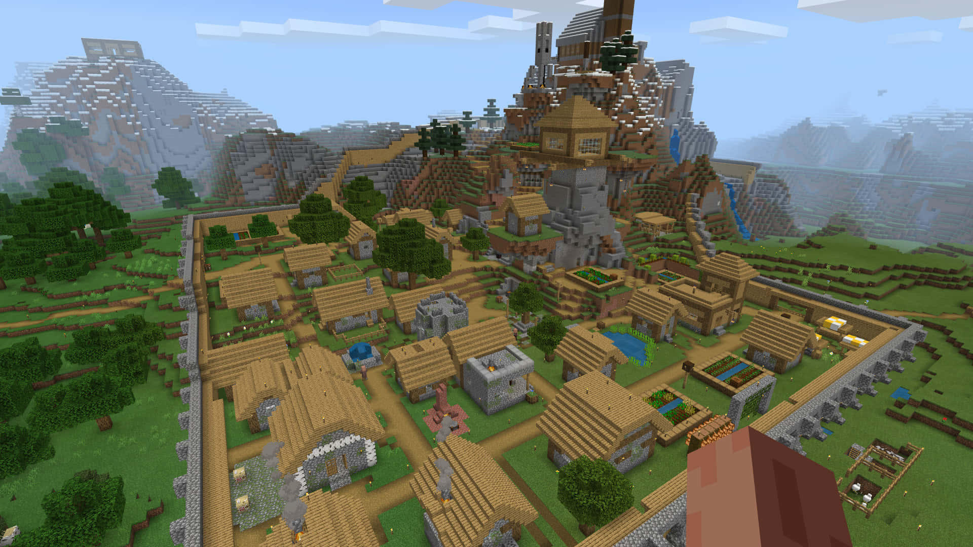 Minecraft Villages 桌布 壁紙 — 一個充滿活力的Minecraft村莊坐落在翠綠的山谷中，背景有山脈和瀑布。