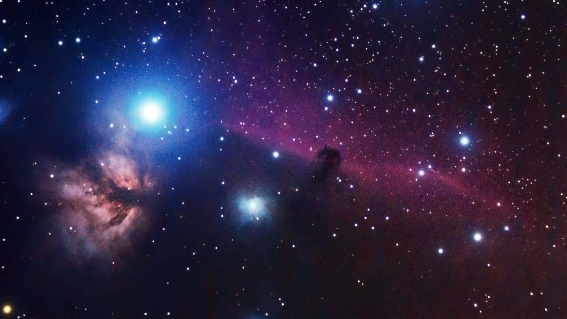 Cool Space 桌布 壁紙 — 一個充滿活力的宇宙星雲，在黑暗的宇宙天空下，以電光藍和深洋紅色在星場中發光。