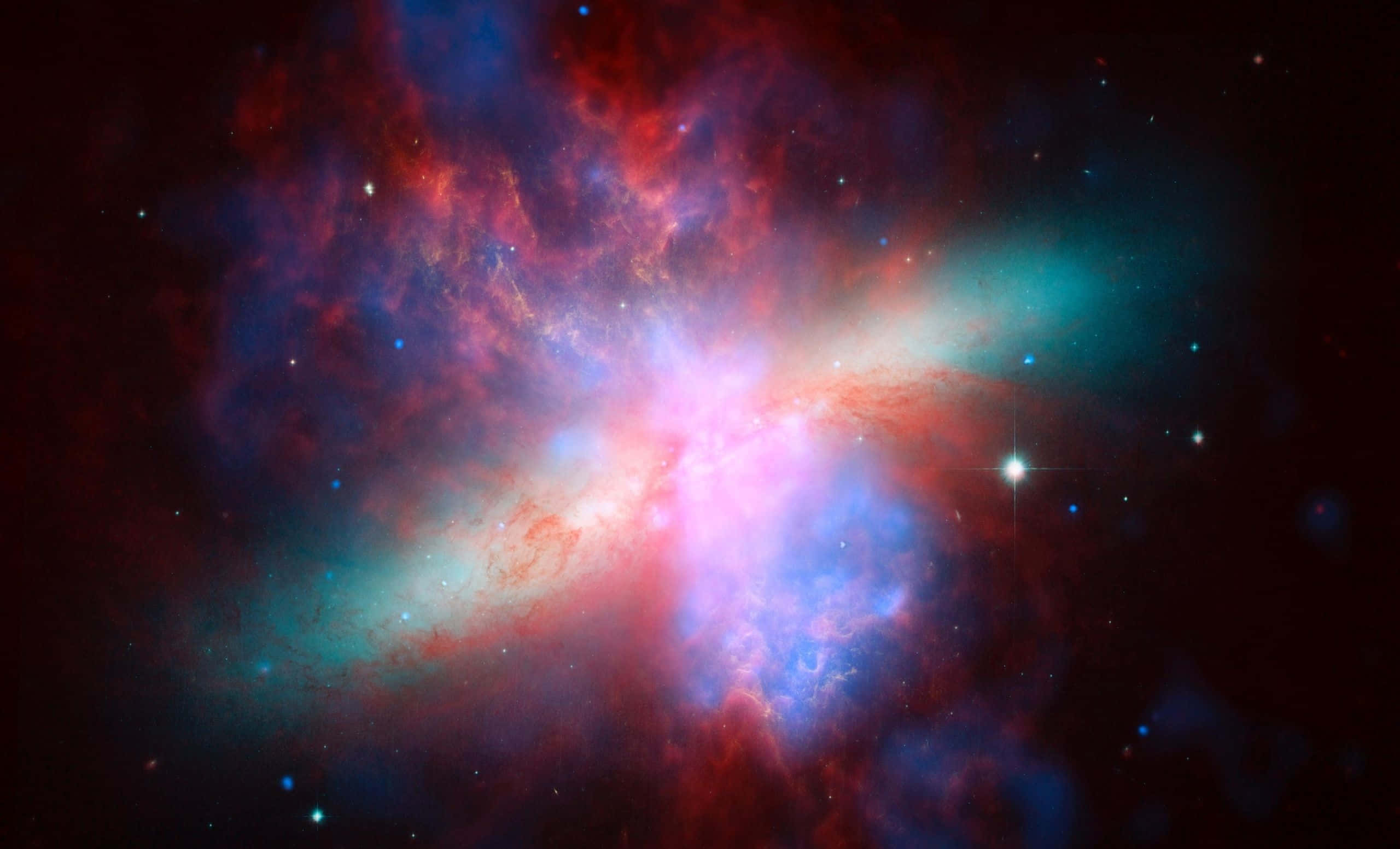 Colorful Space 桌布 壁紙 — 一個充滿活力的宇宙星雲，在黑暗虛空中由明亮恆星照亮的紅色、藍色和粉紅色氣體旋轉。