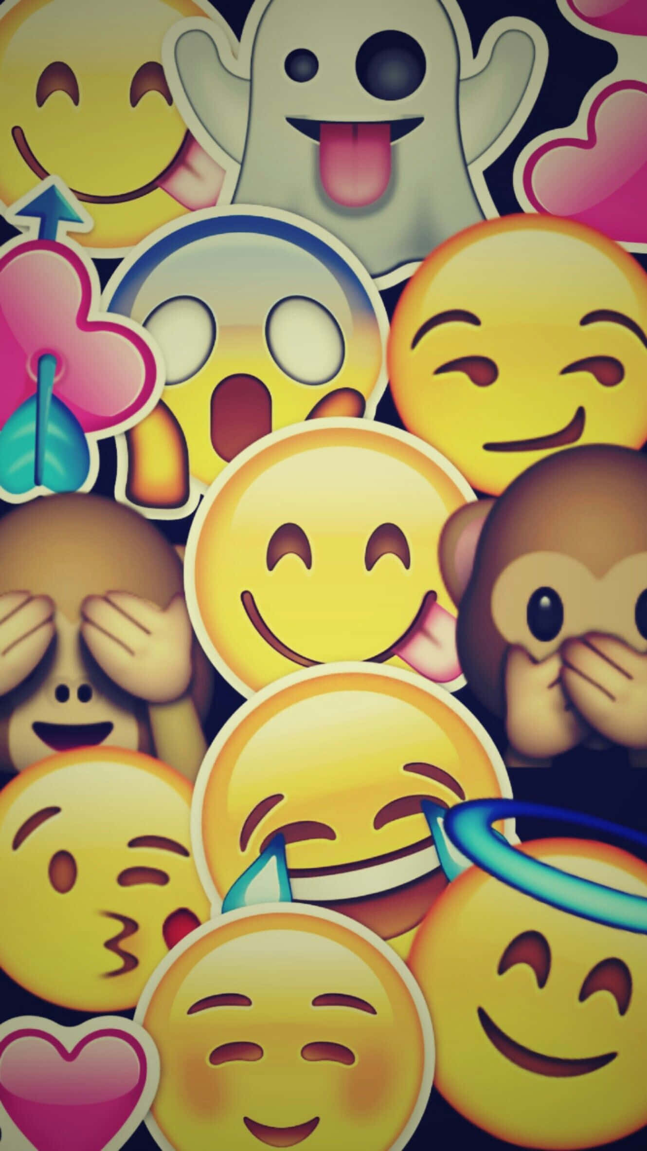 Animojis 桌布 壁紙 — 一個充滿活力的拼貼畫，包含色彩繽紛的表情符號貼紙，包括笑臉、鬼魂、心形和猴子，以俏皮混亂的圖案重疊在一起。