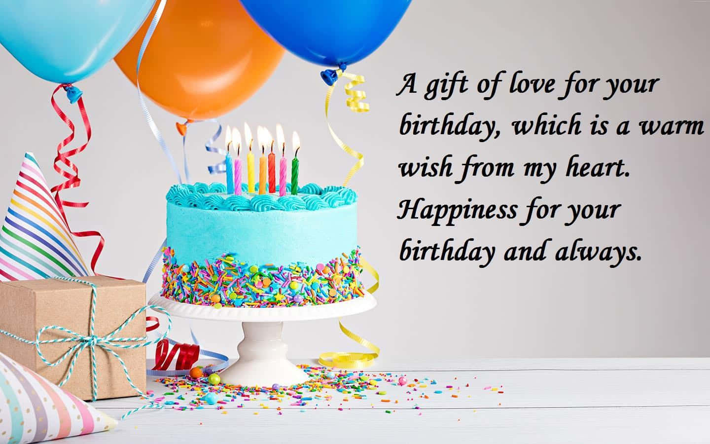 Birthday Wishes 桌布 壁紙 — 一個充滿活力的生日蛋糕，上面有燃燒的蠟燭和彩色糖粒，旁邊有氣球和禮物盒，放在白色桌子上。