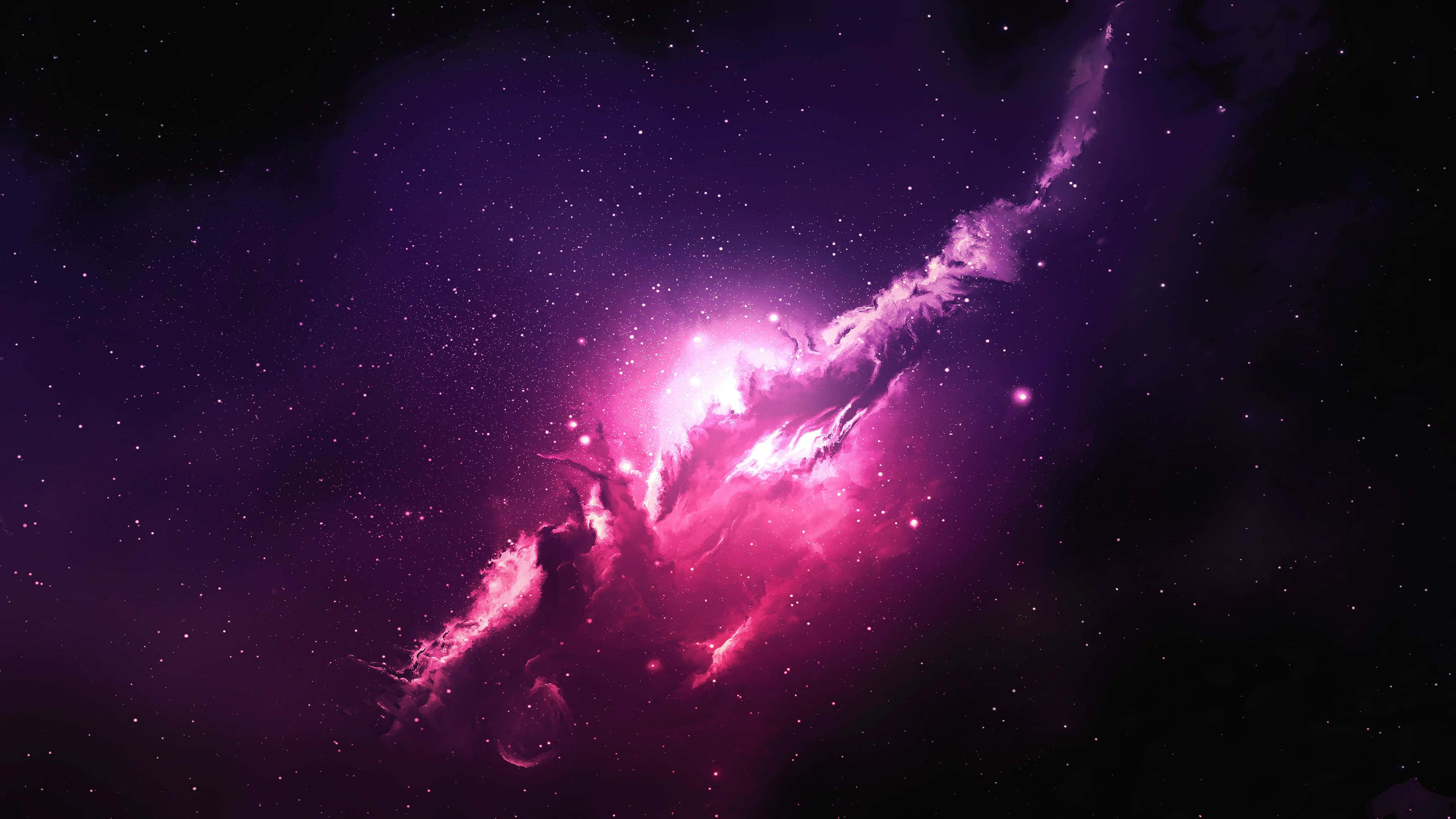Pink Galaxy 桌布 壁紙 — 一個充滿活力的粉紅色和紫色星雲，在繁星點點的宇宙背景下發光，伴隨著旋轉的宇宙塵埃和耀眼的光芒。