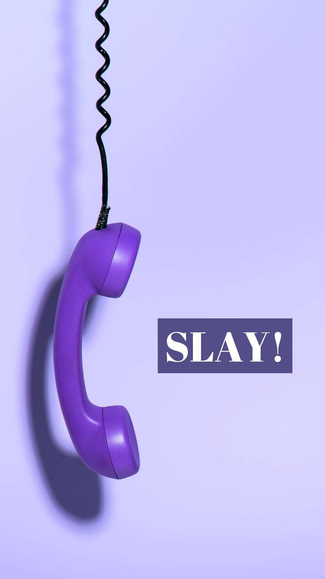 iPhone Baddie Slay 壁紙 — 一個充滿活力的紫色復古電話聽筒掛在它的螺旋線上，背景是柔和的薰衣草色，附近顯示著SLAY!這個詞。
