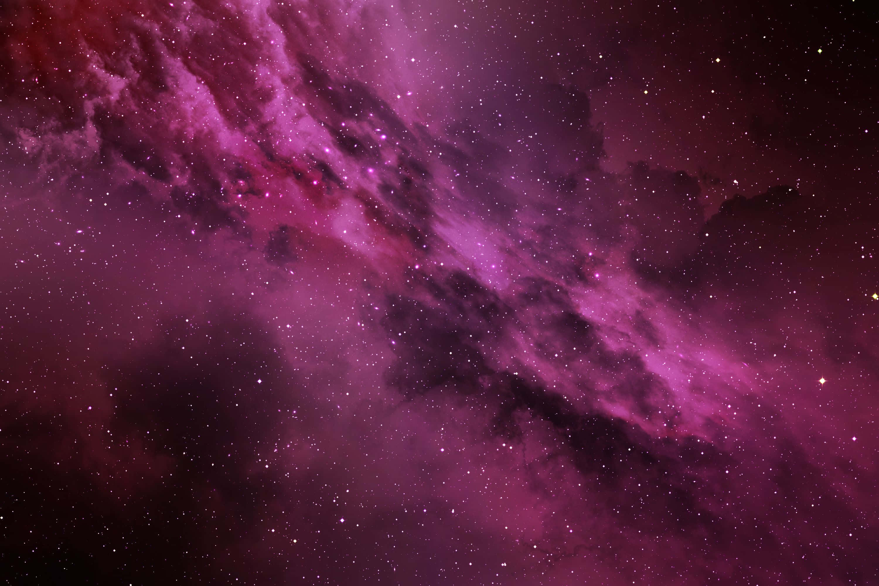 Pink Stars 桌布 壁紙 — 一個充滿活力的紫色星雲，在深邃的太空背景下，與宇宙塵埃和發光的星星一起旋轉。