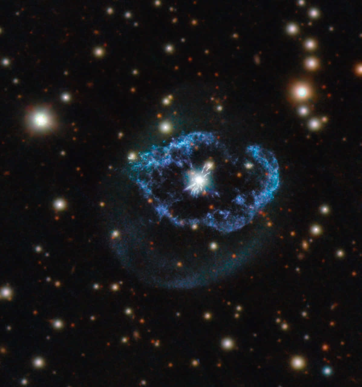 Planetary Nebula 桌布 壁紙 — 一個充滿活力的藍色星雲，中心有一顆明亮的恆星，在黑色宇宙虛空中，周圍散佈著遙遠的橙色和白色恆星，散發著光芒。