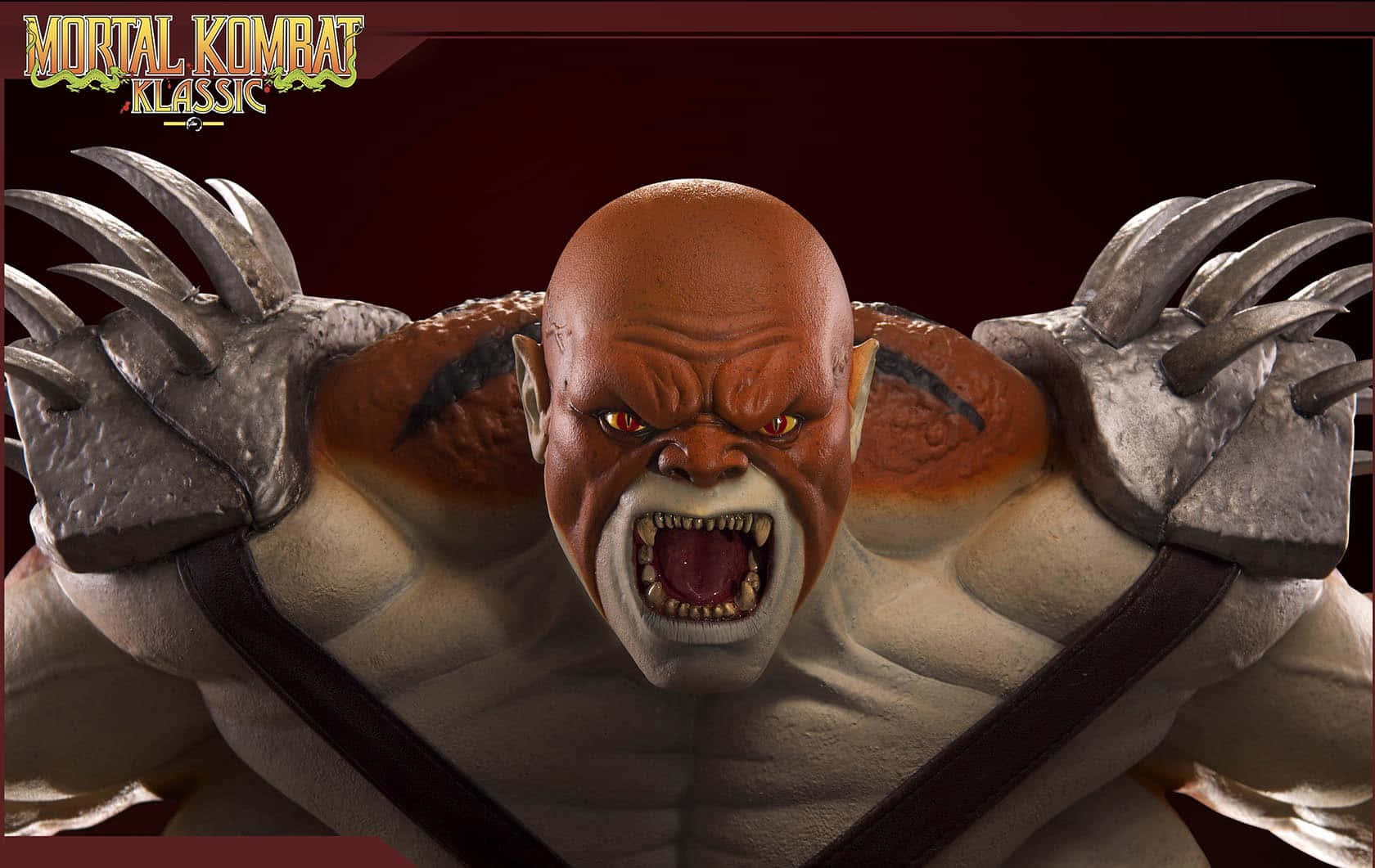 Mortal Kombat Kintaro 桌布 壁紙 — 一個兇猛的光頭戰士，擁有發光的紅色眼睛和金屬爪手套，在黑暗的攝影棚中咆哮。