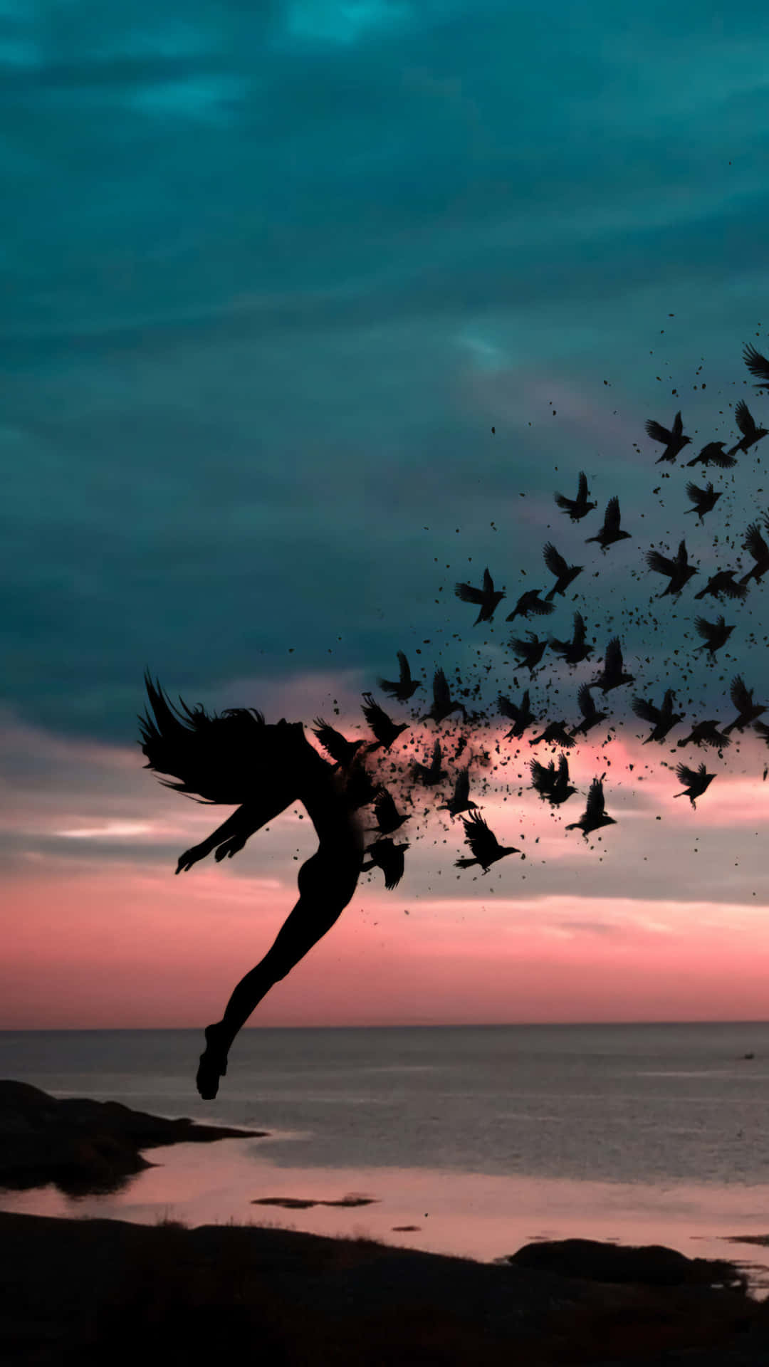Freedom 桌布 壁紙 — 一個剪影人物在日落時從懸崖跳下，鳥兒從他們的身影中散開，映襯著青綠色和粉紅色的天空。