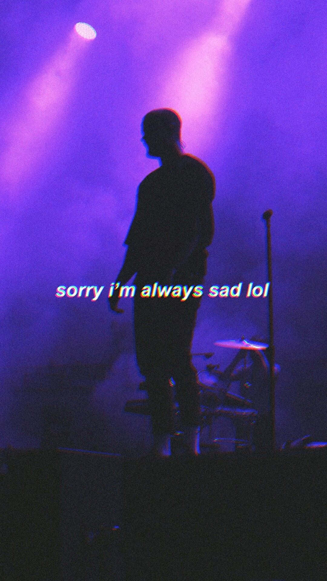 sadness 桌布 壁紙 — 一個剪影音樂家站在煙霧彌漫、被紫色燈光籠罩的舞台上，文字疊加顯示「sorry i'm always sad lol」。