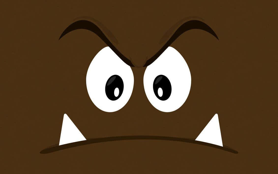 Goomba 桌布 壁紙 — 一個卡通風格的棕色栗寶寶，帶有憤怒的眉毛、大眼睛和鋒利的白色尖牙，在純棕色背景上強烈凝視。