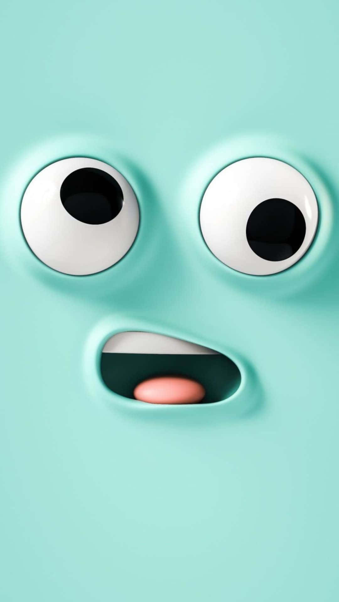 Kawaii Emoticon 桌布 壁紙 — 一個可愛的薄荷綠色卡通角色的特寫，有大眼睛和張開的嘴巴，露出粉紅色的舌頭。