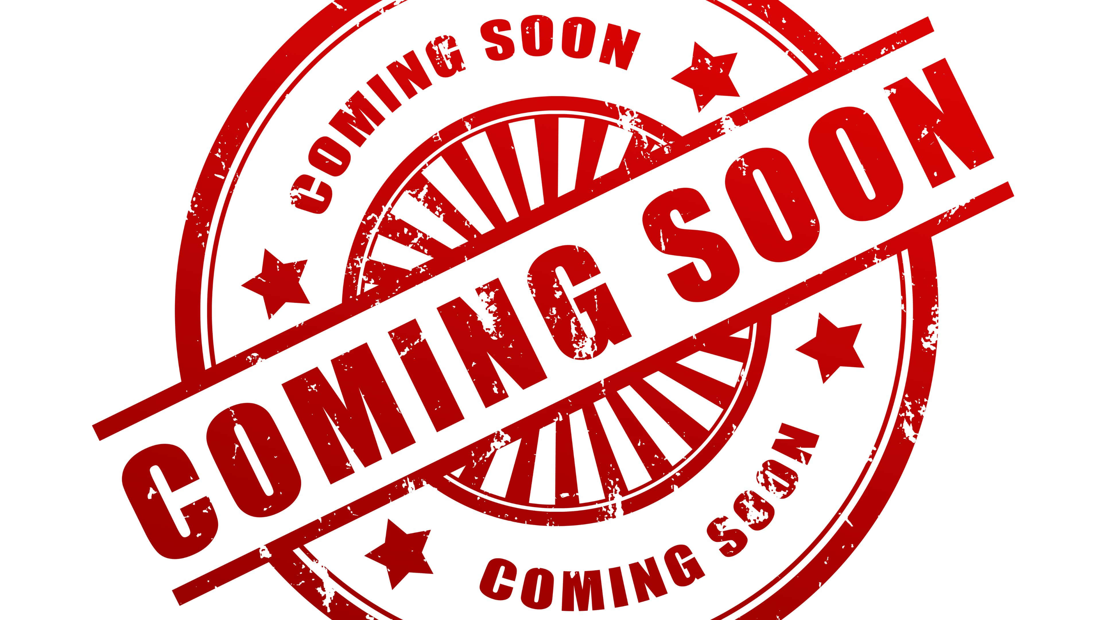 Coming Soon 桌布 壁紙 — 一個大膽的紅色磨損印章，在白色背景上以圓形設計顯示「COMING SOON」，帶有星星和太陽光線圖案。