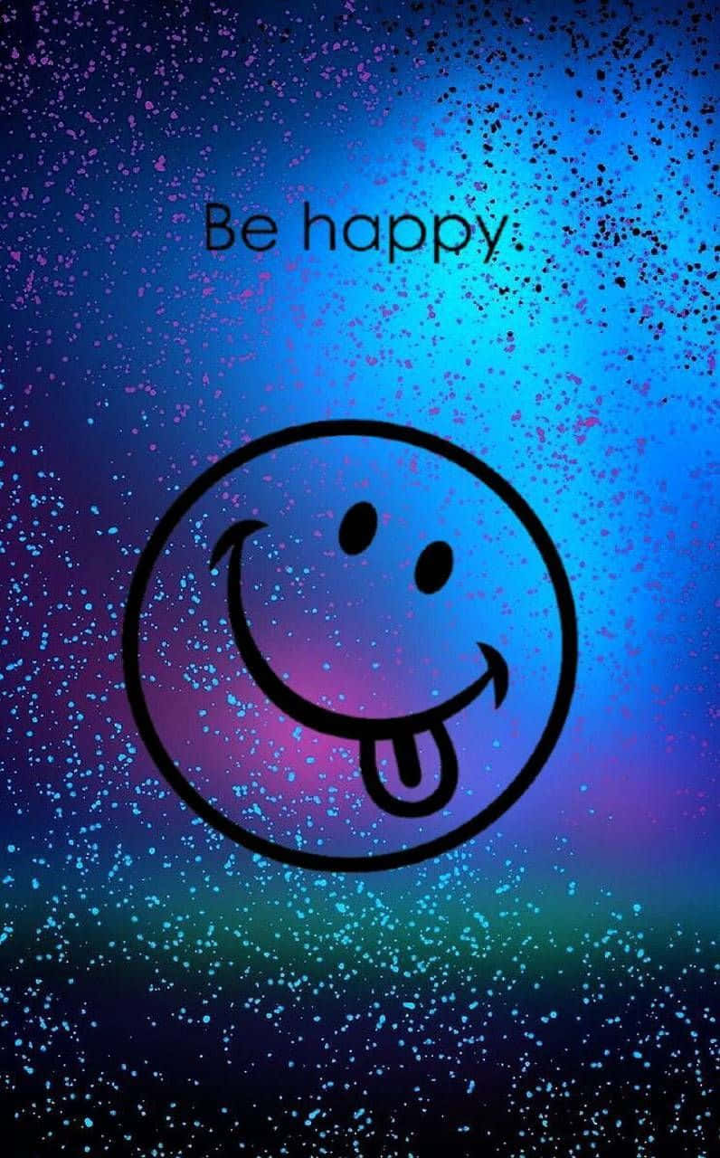 Cheerful 桌布 壁紙 — 一個大膽的黑色輪廓，一個頑皮伸出舌頭的笑臉，漂浮在充滿藍色、紫色和藍綠色斑點的鮮豔宇宙背景上，上方有文字 'Be happy'。