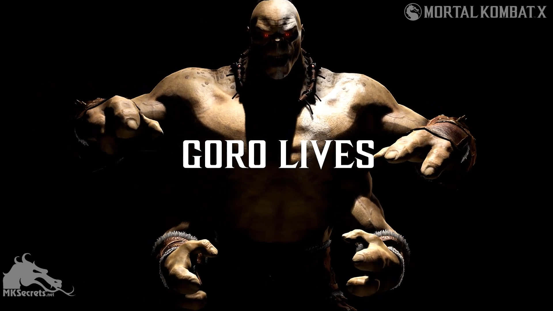 Mortal Kombat Goro 桌布 壁紙 — 一個威猛的肌肉發達、類似大猩猩的戰士，擁有發光的紅色眼睛和尖刺腕帶，站在黑色背景前，上面有粗體白色字樣的「GORO LIVES」。
