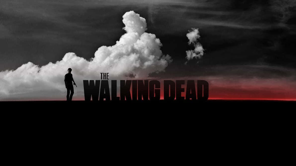 一個孤獨的人物站在標題《The Walking Dead》前，背景是帶有紅色地平線的黑暗天空。 — 行屍走肉 GIF 壁紙