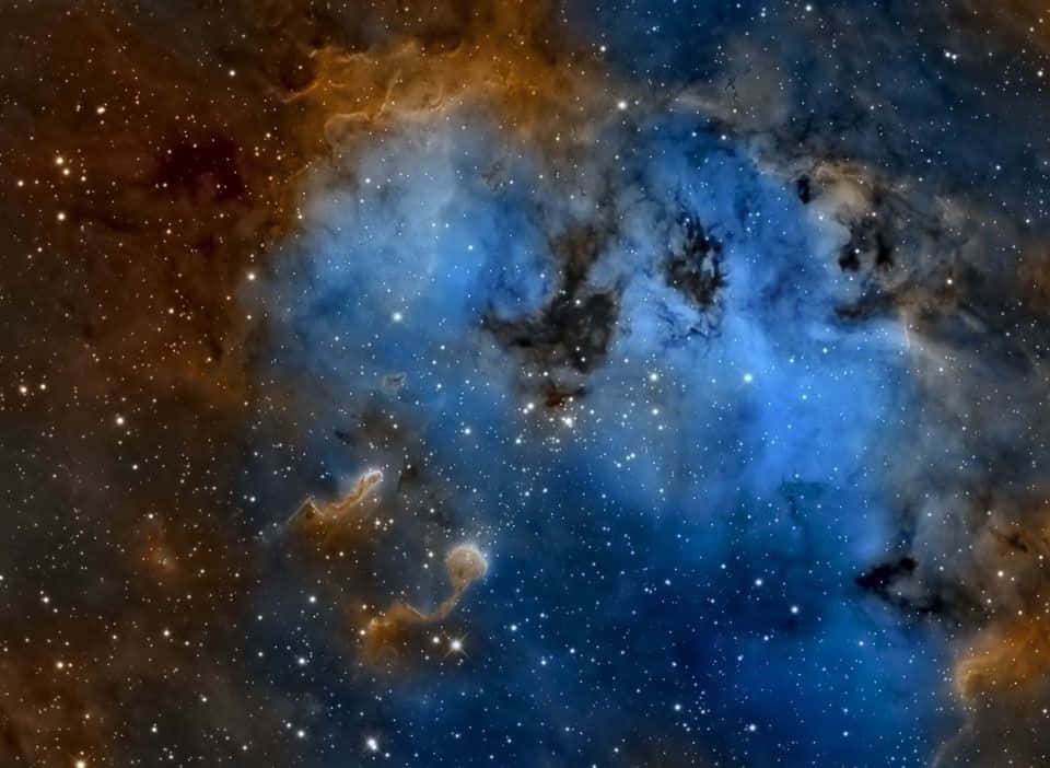Interstellar Cloud 桌布 壁紙 — 一個宇宙星雲在星空中以鮮豔的藍色和橙色旋轉，散發著天體能量。