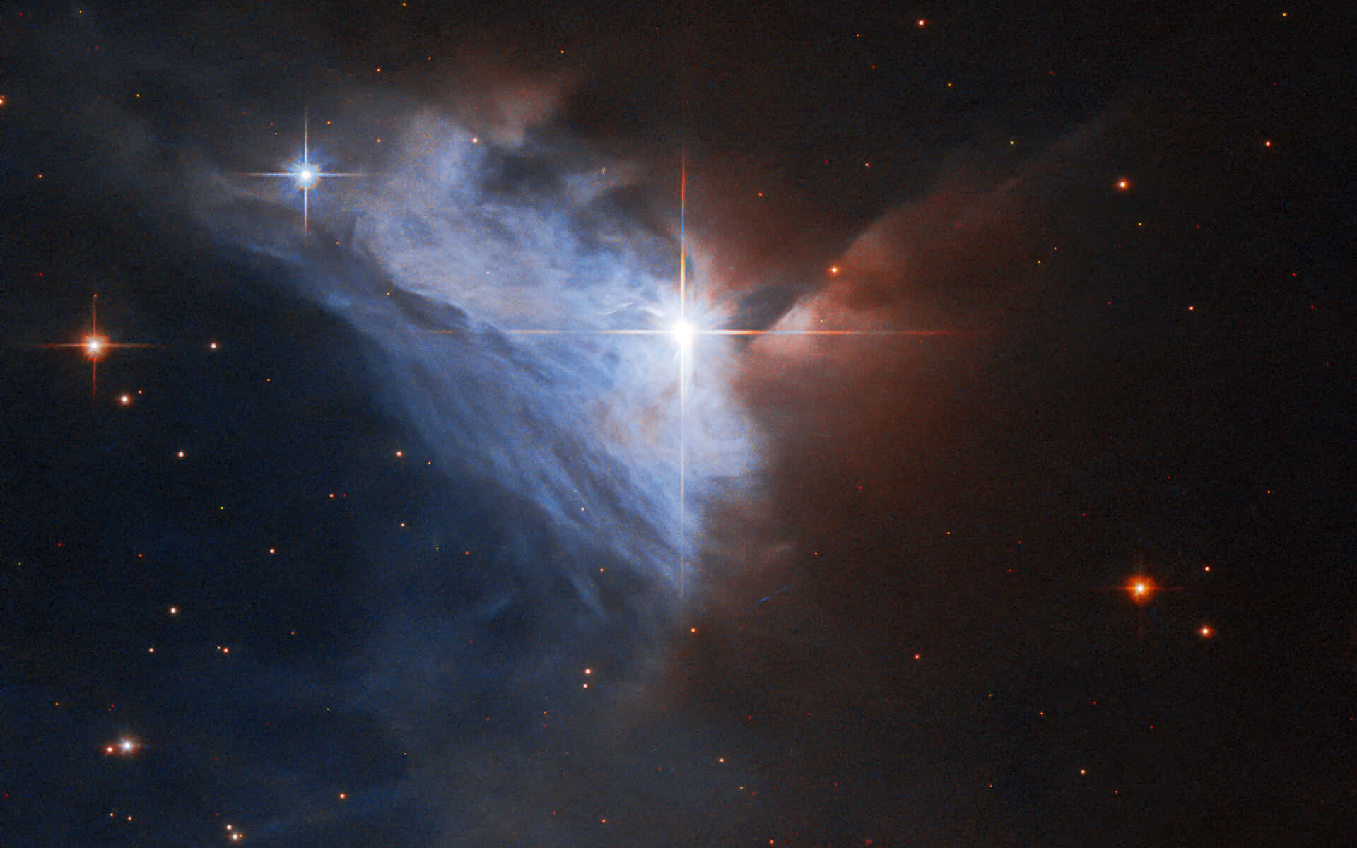 星雲 桌布 壁紙 — 一個宇宙星雲在黑暗的星場中發出藍色和紅色的氣體光芒，由明亮的星星照亮。