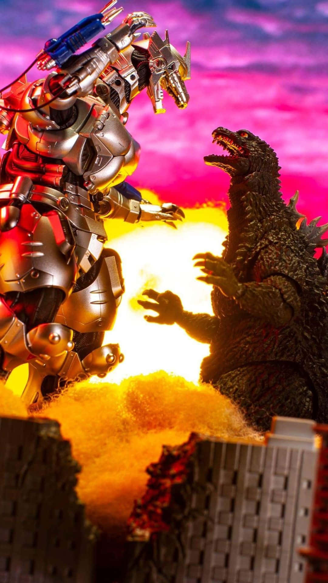 Godzilla Vs Mechagodzilla 桌布 壁紙 — 一個巨型機械人和哥斯拉在一個廢墟城市上空，在充滿活力的粉紅色和紫色天空下，於一場熾熱的爆炸中碰撞。